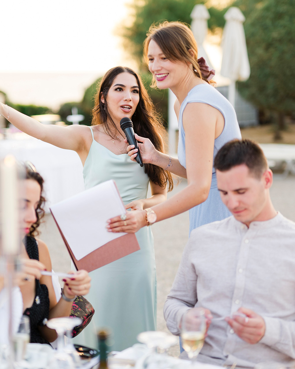 Host asks a question to a guest at a wedding