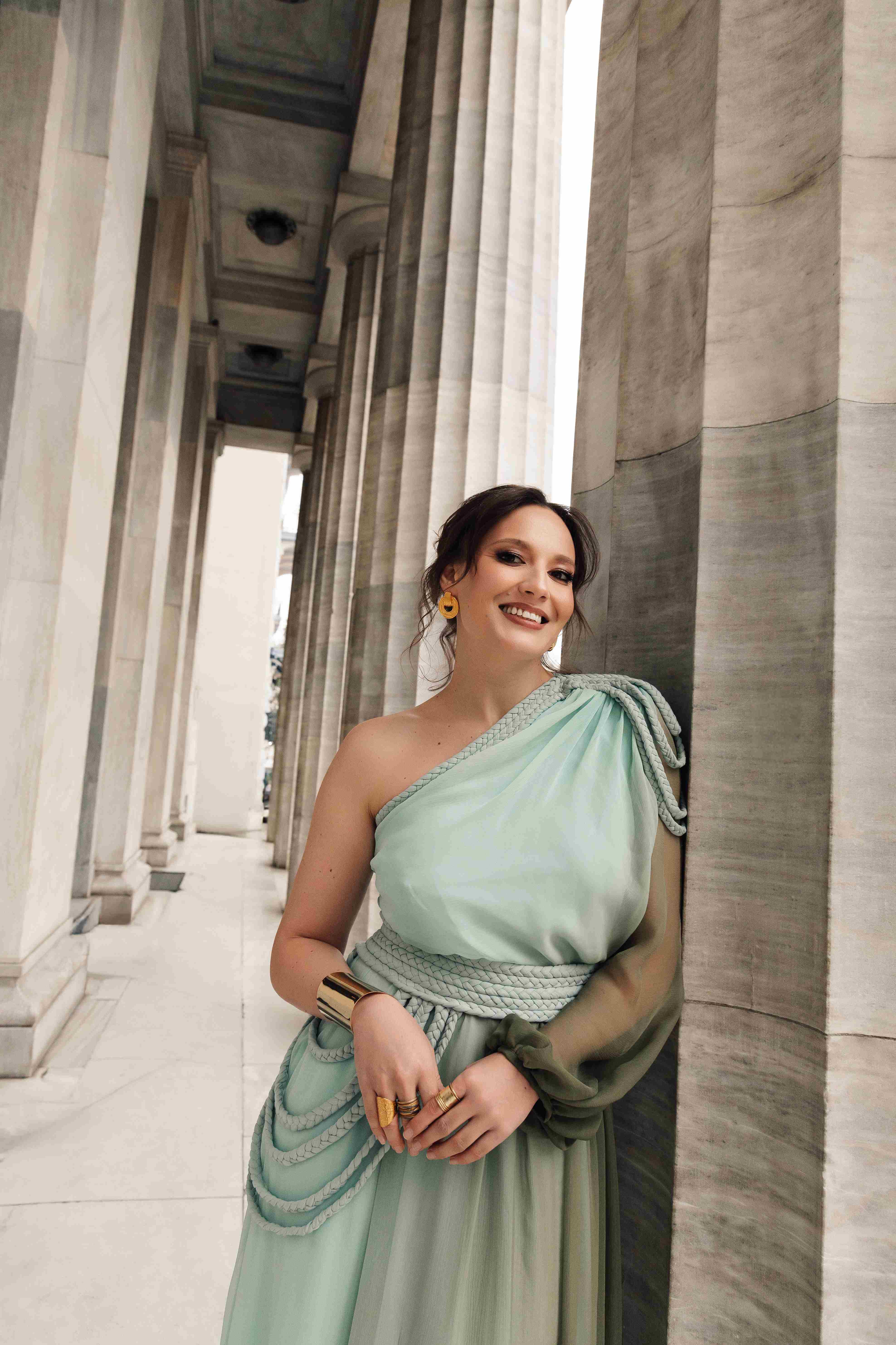 Woman in olive dress poses for photographer
